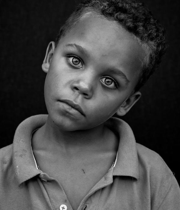 Child calmly balancing on one leg with eyes closed.